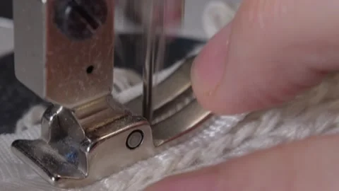 The close-up of the sewing machine needle in slow motion. The seamstress sews Stock Footage 220929016