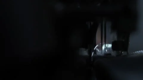 The close-up of the sewing machine needle in slow motion. The seamstress sews Stock Footage 220929077