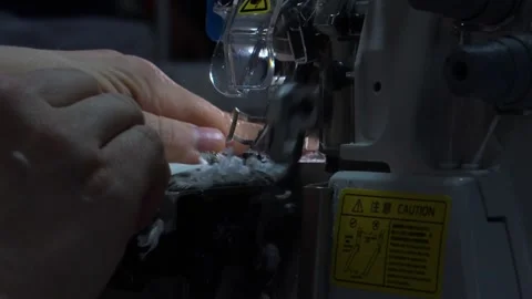 The close-up of the sewing machine needle in slow motion. The seamstress sews Stock Footage 221179237