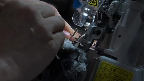 The close-up of the sewing machine needle in slow motion. The seamstress sews Stock Footage 221179295