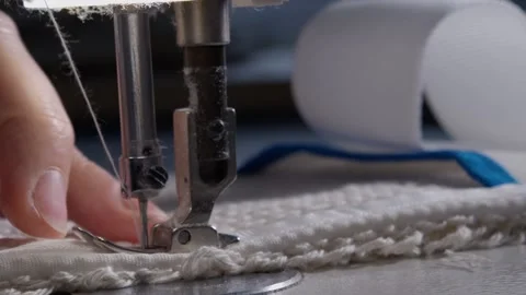 The close-up of the sewing machine needle in slow motion. The seamstress sews Stock Footage 221179342