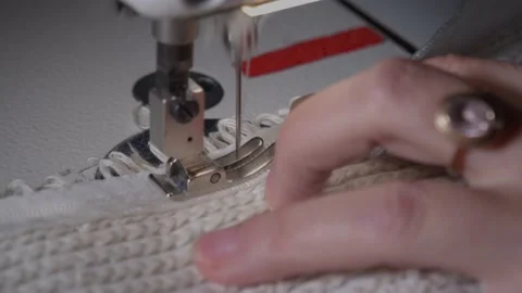 The close-up of the sewing machine needle in slow motion. The seamstress sews Video stock 222133195
