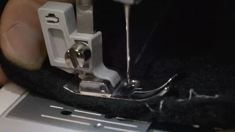 Close-up of sewing machine needle slowly moves up and down Stock Footage 121897767