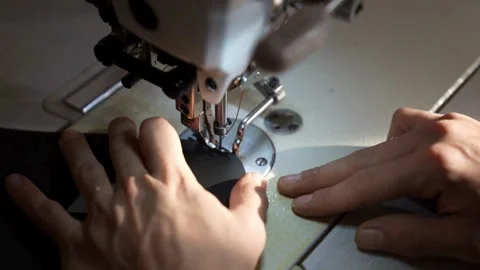Close-up of a sewing machine needle stitching dark fabric Stock Footage 339160107