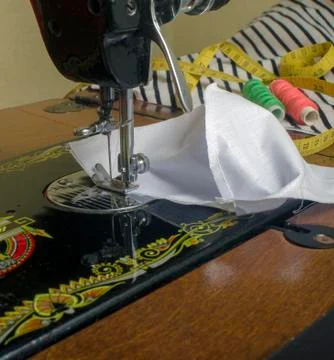 Close-up of Sewing Machine Needle with Thread and fabric. the conceptual idea Stock Photos