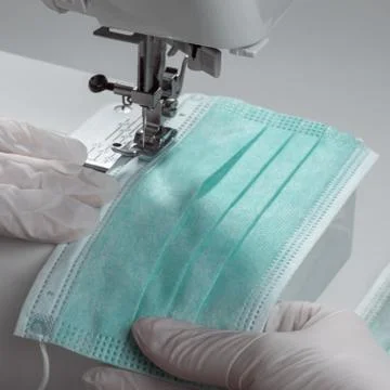 Close up on sewing machine needle while making protection mask Foto stock