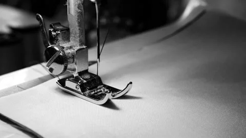 Close up of sewing machine needle on white fabric with slow motion. Stock Footage 134137336