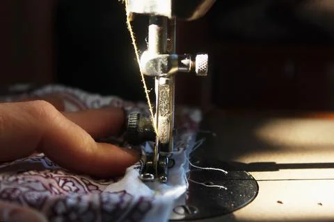 Close-up of a sewing machine in the process of sewing Stock Photos