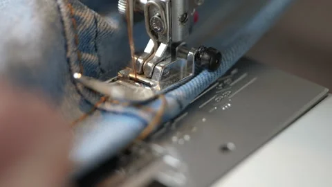 Close-up of sewing machine stitching denim fabric Stock Footage 344283449