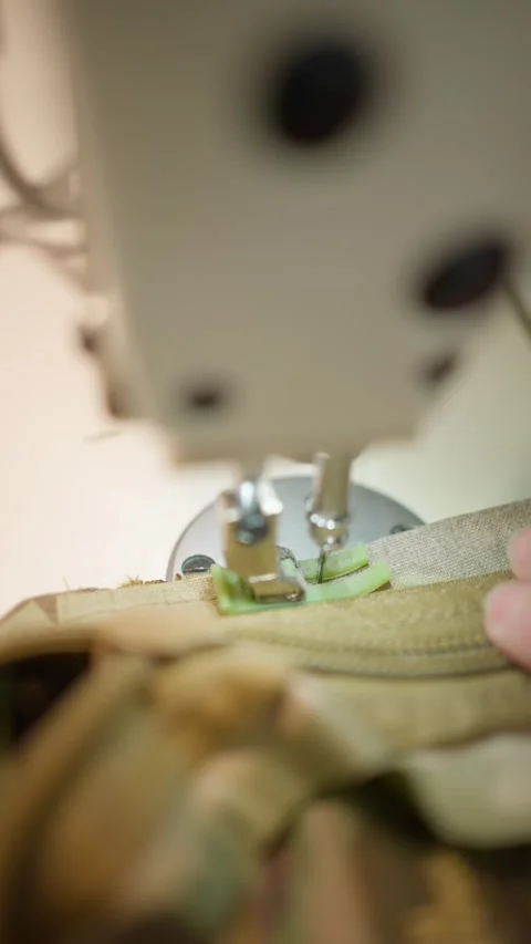 Close-up of sewing machine stitching fabric. Concept of tailoring military Stock Footage 293507627