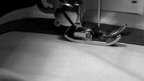 Close-up of a sewing machine while a tailor uses it Stock Footage 103364557