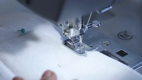 Close-up of sewing machine working with a white fabric. Stock Footage 225584053