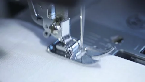 Close-up of sewing machine working with a white fabric. Stock Footage 225584076