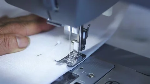 Close-up of sewing machine working with a white fabric. Stock Footage 225584120
