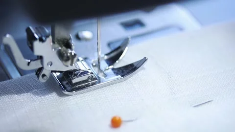 Close-up of sewing machine working with a white fabric. Stock Footage 225584146