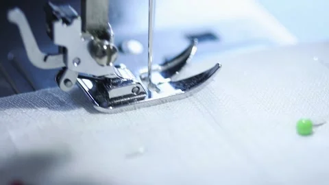 Close-up of sewing machine working with a white fabric. Stock Footage 225584191