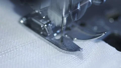 Close-up of sewing machine working with a white fabric. Stock Footage 225584226