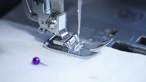 Close-up of sewing machine working with a white fabric. Stock Footage 225584244