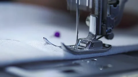 Close-up of sewing machine working with a white fabric. Stock Footage 225584248