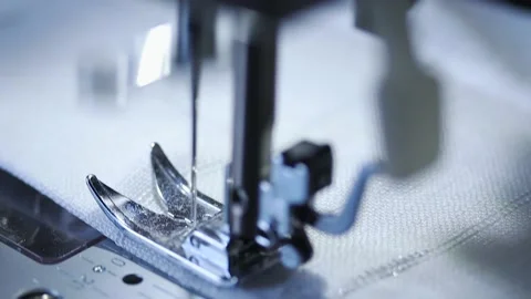 Close-up of sewing machine working with a white fabric. Stock Footage 225584301