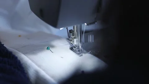 Close-up of sewing machine working with a white fabric. Stock Footage 225584362
