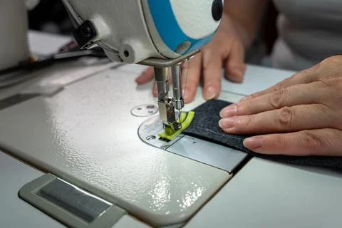 Close up of sewing process with fabric and sewing machine Stock Photos