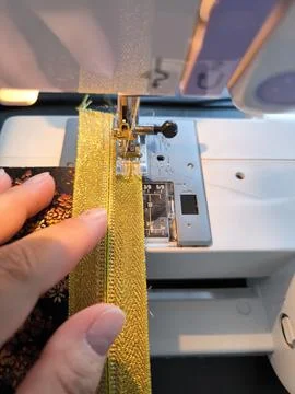 Close-up of sewing process on a sewing machine with a detailed view of the pr Stock Photos