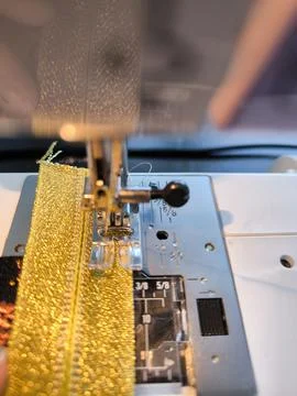 Close-up of sewing process on a sewing machine with a detailed view of the pr Stock Photos