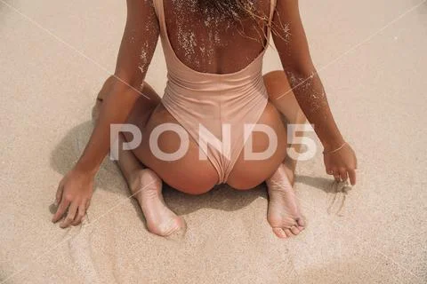 Premium Photo  Women's ass with sand