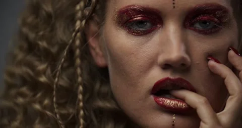Close up of a sexy model with bright red makeup and lipstick, touching her face Stock Footage 143961170
