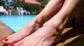 Close up of Sexy Woman Sunbathing near Swimming Pool. Slow Motion. HD Footage