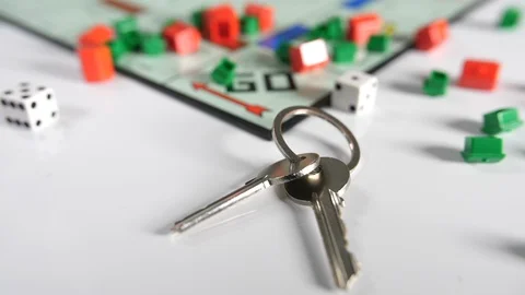 Close up of shaking double dice and new house door keys scattered Stock Footage 89192125