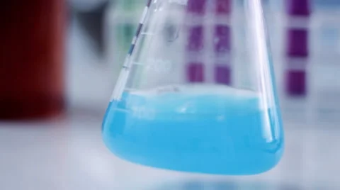 Close-up of shaking Erlenmeyer flask with blue substance HD Stock Footage 2795024
