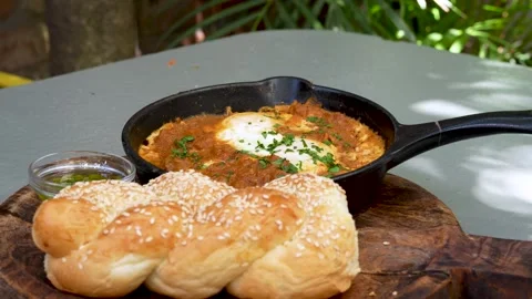 Close Up Shakshuka With Poached Eggs and Sesame Bread Stock Footage 341827087