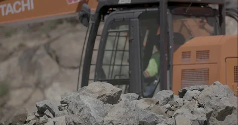 Close Up Shallow Depth of Field Excavator Excavating rock Construction Site Stock Footage 77308265