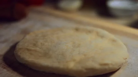 Close-up of a shaped piece of dough prepared to be rolled with a rolling pin Stock Footage 144825205