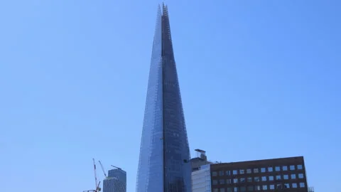Close-up of the Shard tower reaching into the sky on a sunny afternoon in London Stock Footage 321685826