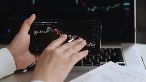 Close up of share trader at desk writing in notebook with stock price data Stock Footage 194831024