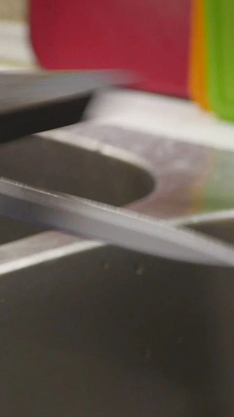 Close-Up Of A Sharp Knife Blade With Colorful Background. Vertical. Stock Footage 302553134