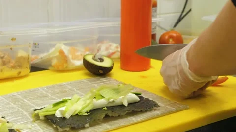 A Close-up of A Sharp Knife is cutting the red tomatoes. Preparing sushi, maki Stock Footage 237520446