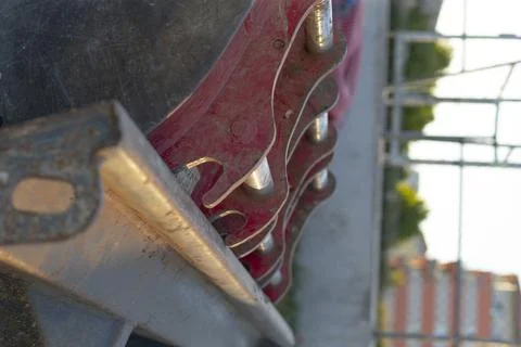 Close-up of sharp metal cutting machinery with blurred outdoor background Stock Photos