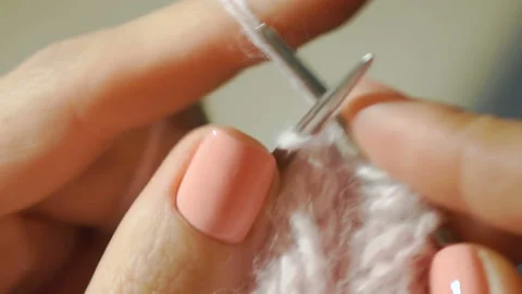 Close-up of a sharp needle for knitting captures the next loop of yarn Stock Footage 89067221