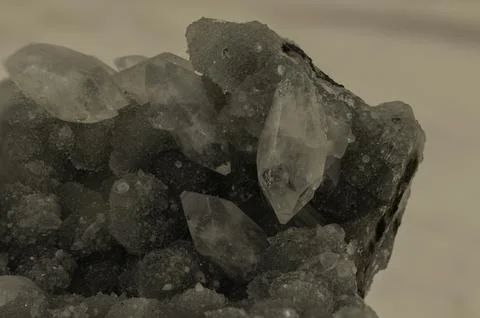 Close-up of sharp quartz crystals emerging from a rough green matrix, highl.. Stock Photos