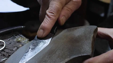 Close up of sharpen the blade on the stone, shoemaker work process Stock Footage 279748993