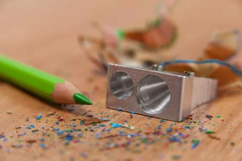 Close-up of sharpener and colored pencil with shavings Stock-Fotos