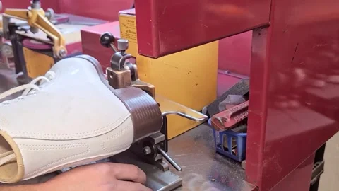 Close-up of sharpening a figure skate on equipment, sparks flying. Stock Footage 247995762