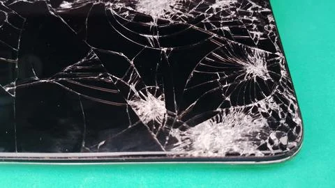 Close up of a shattered smartphone screen with complex fractures Stock Photos