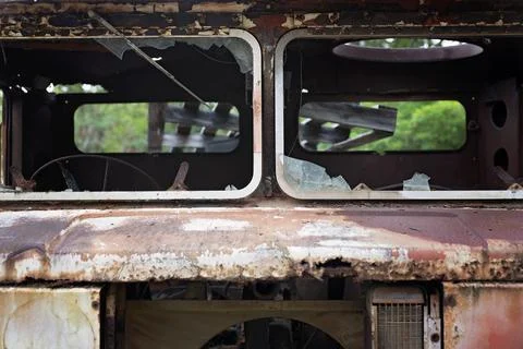Close-up of a shattered windshield on a rusted, abandoned truck in a forest.. Stock Photos