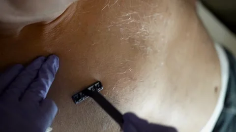 Close-up shave on man's chest, indoor setting Stock Footage 265384951