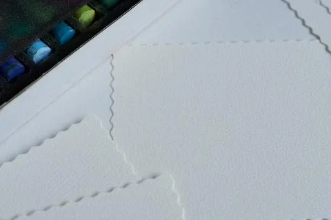 Close-up of a sheet of paper and a box with wax crayons Stock Photos